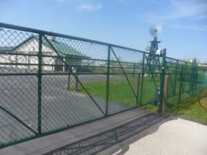 picture of a green chainlink fence sliding gate