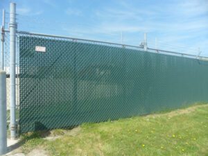 a chainlink fence with green privacy slats