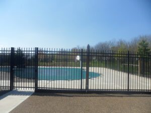 side shot of a black metal fence built around a pool