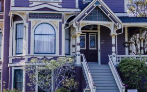 a photo of the front of a purple 2 story house