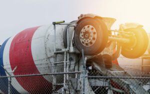 a concrete truck behind a barbed wire fence
