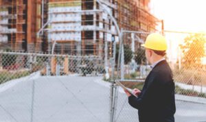 a broken fence being inspected by a job site inspector