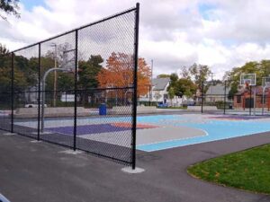 tall chainlink fencing by a basketball court