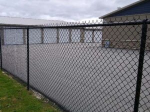 black chainlink fence around a storage facility