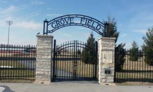 a black fence and gate labled grove field