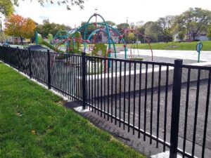 black ornamental fence surrounding a playground
