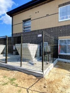 tall black security fence surrounding a electrical installation