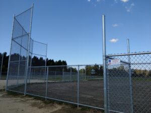 a baseball diamond surrounded by a chainlink fence