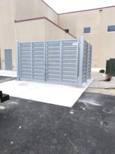 a gray metal privacy fence with front gates