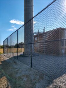 backside of a large black chainlink fence