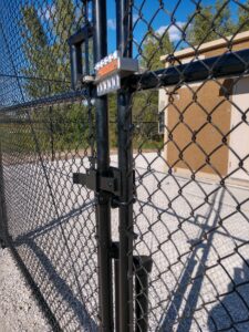 closeup of a black fence gate and security lock