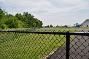 a black chainlink fence around a playground