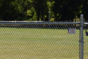 chainlink fence closeup with the patriot fence logo