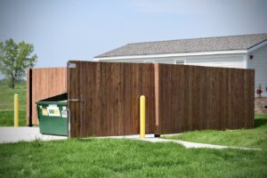 a wooden privacy fence built around a trash receptacle with the gates open