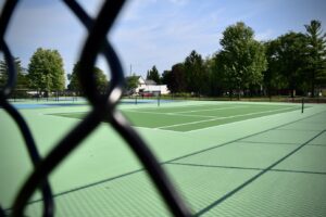 a pickle ball court picture taken through a closeup chainlink fence