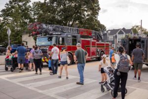people in the street around a firetruck