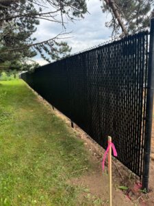 black slat fence built outside of a pizza ranch