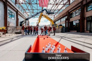 employees duck pin bowling in a construction site